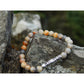 Handmade, natural Crazy agate bracelet, beautiful brownish nuance 6 mm bead stretch bracelet, with a long metal Tibetan style bead, sitting on a rock on the Irish shore in West Cork