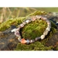 Handmade, natural Flower agate bracelet, beautiful brownish nuances, 2.5x8 mm bead stretch bracelet with a small metal Tibetan style bead, sitting on a rock on the Irish shore in West Cork