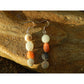 Handmade, natural Amazonite gemstone earrings, made using  4 different coloured 9.6mm tumble stones. Metal parts are stainless steel. The background is the Irish rocky shore of West Cork