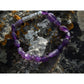 Handmade, natural Amethyst gemstone bracelet, beautiful purple 6x8 mm nuggets with a long metal bead as well, sitting on a rock on the Irish shore in West Cork