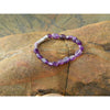 Handmade, natural Amethyst gemstone bracelet, beautiful purple 6x8 mm nuggets with a long metal bead as well, sitting on a rock on the Irish shore in West Cork