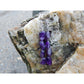 Handmade, natural Amethyst gemstone earrings made with 4 beautiful purple 6x8 mm nuggets. Metal parts are stainless steel. The background is the Irish rocky shore of West Cork.
