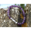 Handmade, natural frosted Amethyst gemstone bracelet, beautiful purple 6x8 mm nuggets with a long metal bead, Tibetan style, sitting on a rock on the Irish shore in West Cork