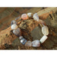 Handmade, natural Botswana agate bracelet, beautiful brownish nuance 8x12 mm bead stretch bracelet, with a small metal Tibetan style bead, sitting on a rock on the Irish shore in West Cork