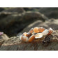 Handmade, natural Botswana agate bracelet, beautiful brownish nuance 8x12 mm bead stretch bracelet, with a small metal Tibetan style bead, sitting on a rock on the Irish shore in West Cork